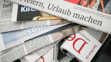 Kirchenzeitung verschiedener Bistümer liegen übereinander / © Harald Oppitz (KNA)