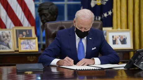 Joe Biden, Präsident der USA, unterzeichnet eine Executive Order zur Einwanderung im Oval Office des Weißen Hauses / © Evan Vucci/AP (dpa)
