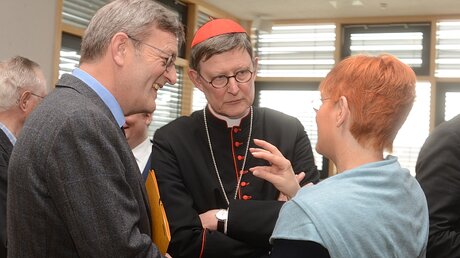 Kardinal Woelki im Gespräch mit Joachim Braun und Stephanie Paeleke, Vertreterin des NRW-Familienministeriums / © Beatrice Tomasetti (DR)