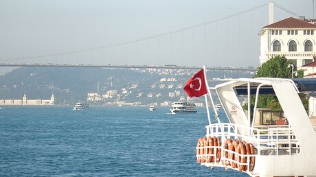 Eine Türkei-Flagge weht vor der Bosporus-Brücke, die seit einem Jahr einen neuen Namen hat: Brücke der Märtyrer des 15. Juli / © Marion Sendker (DR)