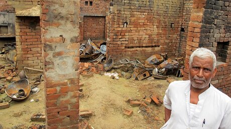 Ein Dalit vor den Trümmern seines Hauses  / © Siddhartha Kumar (dpa)