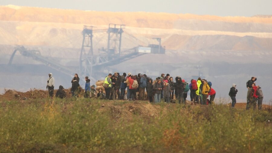 Aktivisten stehen im RWE-Gelände des Hambacher Tagebaus / © David Young (dpa)
