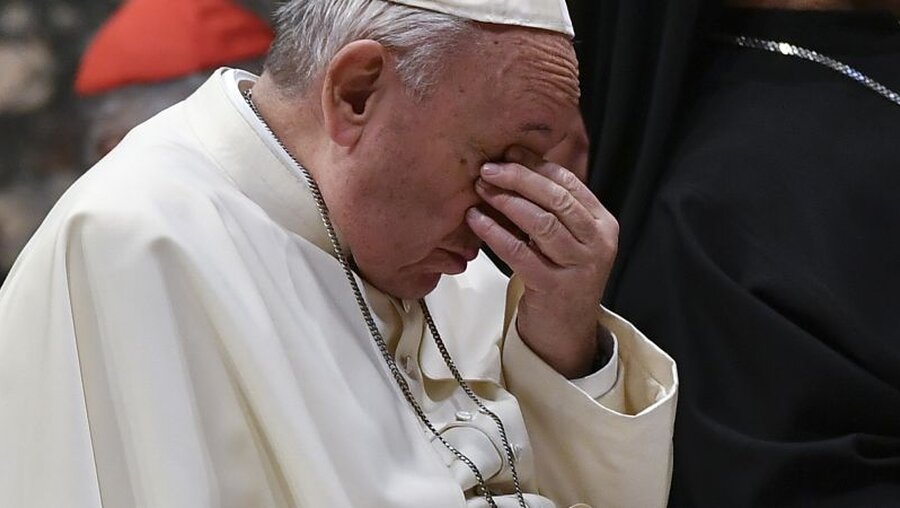 Archivbild: Papst Franziskus hält sich den Kopf. / © Vincenzo Pinto (dpa)