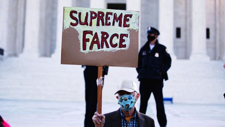 Demonstrant mit einem Schild mit der Aufschrift "Supreme Farce" vor dem Supreme Court in den USA / © Johnny Silvercloud (shutterstock)