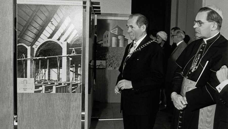 Kardinal Julius Döpfner (r.), Erzbischof von München und Freising, und Josef Henselmann, Präsident der bayerischen Kunstakademie, betrachten ein Foto in der Ausstellung zum Werk des Architekten Rudolf Schwarz in der Akademie der bildenden Künste in München im Juli 1964.  (KNA)