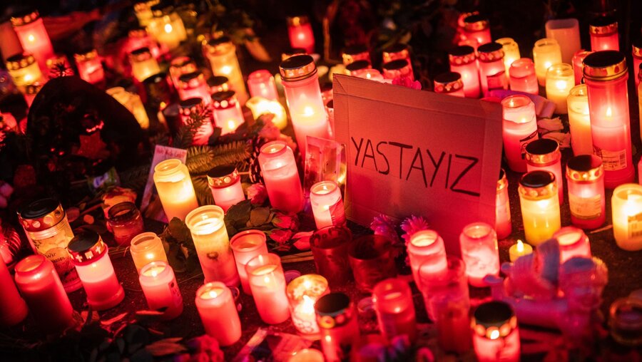 "Yastayiz" - Türkisch für "Wir trauern", steht zwischen zahlreichen Trauerkerzen am Tatort auf einem Schild geschrieben / © Christoph Schmidt (dpa)