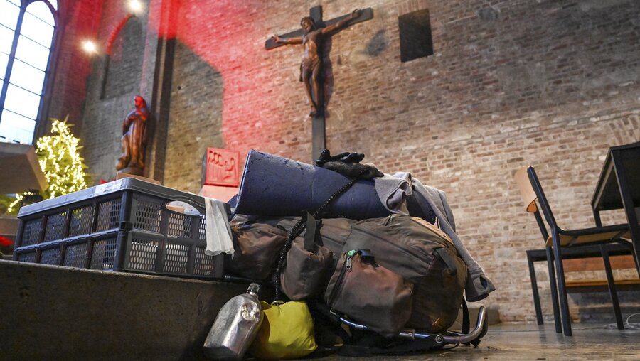 Das Gepäck einer Frau liegt auf den Altarstufen bei einem Obdachlosencafe am 11. Januar 2022 in der ehemaligen Franziskanerkirche Sankt Marien in Köln. / © Harald Oppitz (KNA)