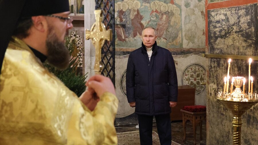 Wladimir Putin feiert allein mit einem Priester eine Messe an Weihnachten. / © Mikhail Klimentyev/Pool Sputnik Kremlin/AP (dpa)