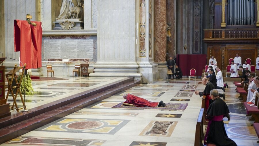 Papst Franziskus liegt auf dem Boden während der Liturgie am Karfreitag / © Andrew Medichini (dpa)