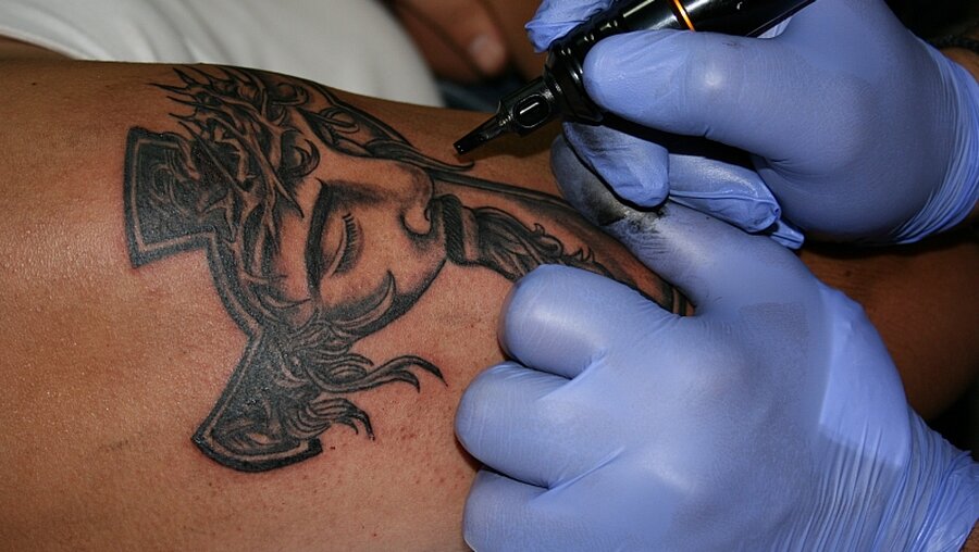 Tattoo mit einem Christus-Bild / © Stefanie Järkel (dpa)