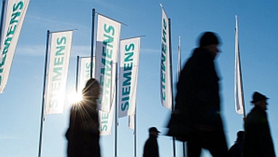Siemens-Fahnen / © Peter Kneffel (dpa)