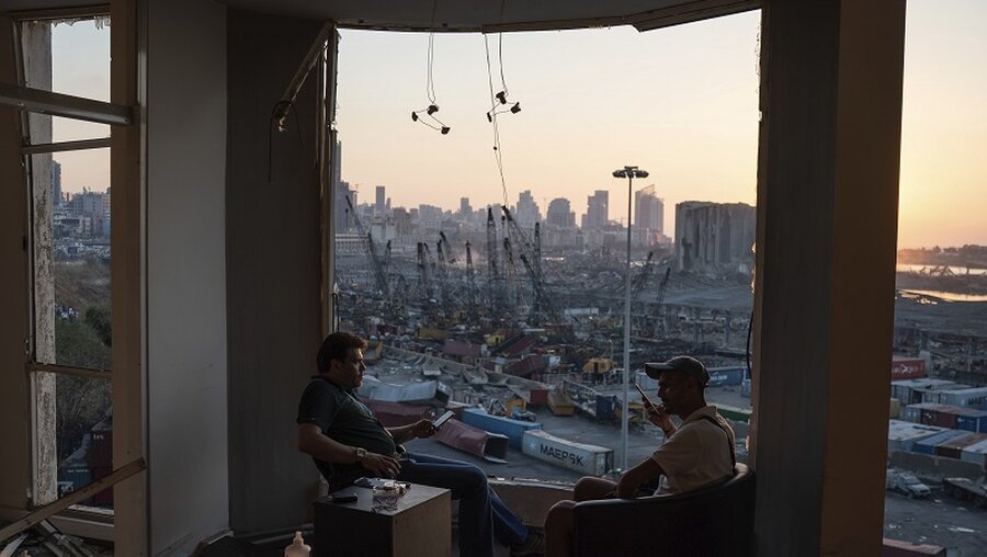  Zwei Männer in einem zerstörten Gebäude gegenüber dem Ort der Explosion in Beirut / © Felipe Dana (dpa)