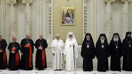Papst Franziskus und Daniel Ciobotea, Patriarch der Rumänisch-Orthodoxen Kirche, stehen mit ihren jeweiligen Delegationen für ein Foto zusammen / © Andrew Medichini (dpa)