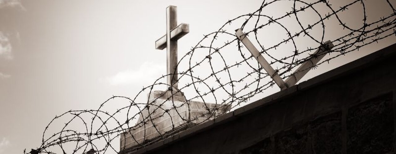 Ein Kreuz hinter Stacheldraht (Symbolbild für Religionsfreiheit) / © Dundanim (shutterstock)
