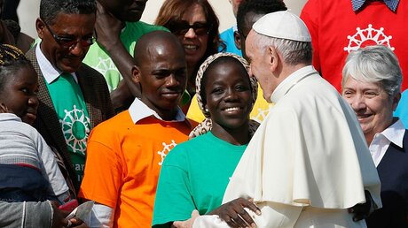 Papst Franziskus begrüßt Migranten / © Paul Haring (KNA)