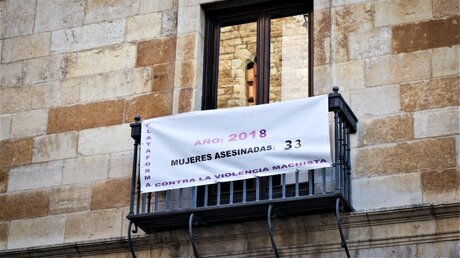 Banner mit Anzahl in Spanien ermordeter Ehefrauen durch häusliche Gewalt / © Andreas Drouve (KNA)