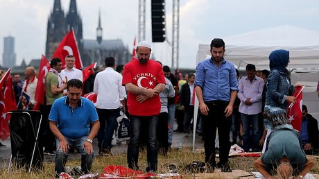 Erdogan-Anhänger beten vor der Kundgebung / © Oliver Berg (dpa)
