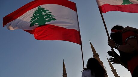 Demonstranten schwenken libanesische Flaggen. / © Marwan Naamani (dpa)