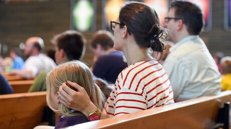 Eine Familie sitzt während des Deutschen Evangelischen Kirchentags am 4.6.15 in Stuttgart in einem Gottesdienst (KNA)