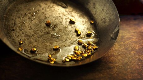 Goldkörner liegen in einer Schale / © optimarc (shutterstock)