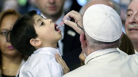 Franziskus gibt einem Jungen eine Polio-Impfung / ©  Alessandro Di Meo (dpa)