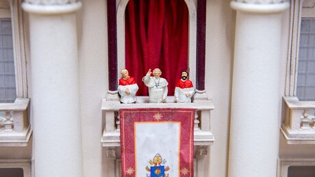 Eine winzige Papst-Figur winkt in einer Werkstatt des "Miniatur Wunderlandes" / © Daniel Reinhardt (dpa)