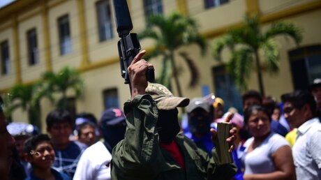 Nicaragua: Ein Mann hebt bei einem Protest gegen die Regierung eine Waffe hoch. / © Carlos Herrera (dpa)