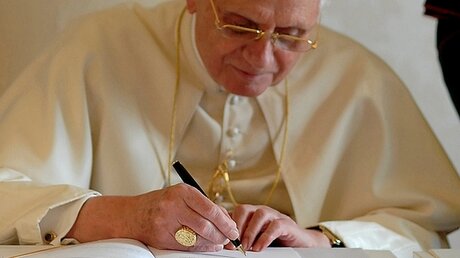 Papst Benedikt XVI. unterzeichnet seine dritte Enzyklika "Caritas in veritate" / © N.N. (KNA)