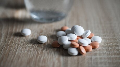 Viele Tabletten und ein Wasserglas - Symbolbild Sterbehilfe / © Julia Steinbrecht (KNA)