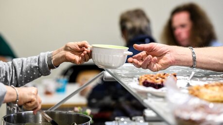 Ehrenamtler helfen bei einer Essensausgabe für Bedürftige / © Harald Oppitz (KNA)