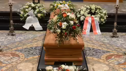 Der blumengeschm&uuml;ckte Sarg ist vor dem Dreik&ouml;nigenschrein aufgebahrt / &copy; Beatrice Tomasetti (DR)