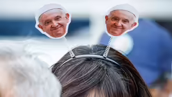Eine Frau trägt einen Haarreif mit kleinen Bildern von Papst Franziskus bei einer Papstmesse im Gelora Bung Karno Stadion in Jakarta / © Vatican Media/Romano Siciliani (KNA)