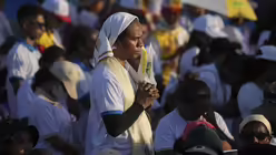 Eine gläubige Katholikin nimmt an der von Papst Franziskus geleiteten heiligen Messe im Tasitolu-Park teil. / © Dita Alangkara/POOL AP/dpa (dpa)