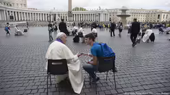 Auf dem Petersplatz nimm Papst Franziskus Jugendlichen überraschend die Beichte ab.  / © Osservatore Romano Handout (dpa)