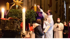 Schulseelsorger Burkhard Hofer zündet die erste Kerze an. / © Beatrice Tomasetti (DR)